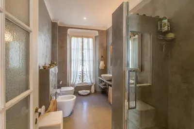 a bathroom with a toilet and a sink and a mirror at Penthouse Lou Lòu by iVillamia com in Nice