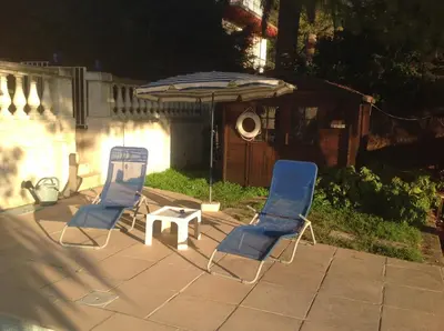 two chairs and a table and an umbrella on a patio at La Nectarine in Nice