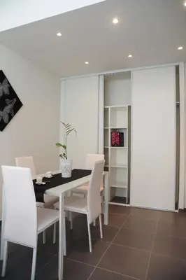 a dining room with a table and white chairs at Suite Imperazur Five stars Holiday House in Nice