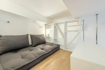 a living room with a gray couch in a room at Grimaldi in Nice