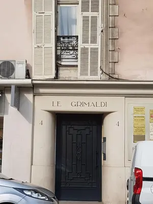 a building with a black door with the words le criminaldir at Grimaldi in Nice