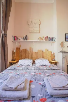 a bedroom with a large bed with towels on it at La Maïoun Guesthouse in Nice