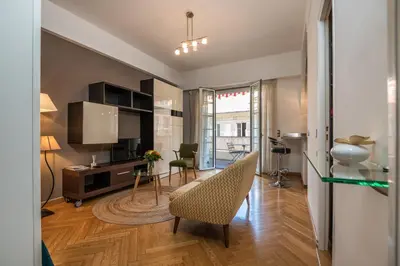 a living room with a table and a chair and a desk at Appartement Musiciens in Nice