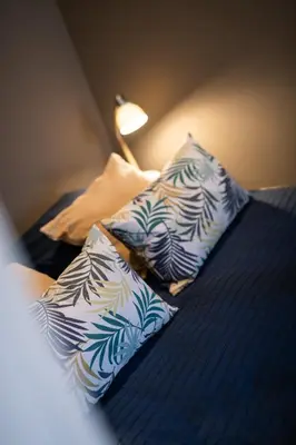 two pillows on a bed with a lamp on it at Appartement Musiciens in Nice