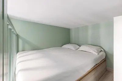 a white bed in a room with a green wall at MY CASA - SAINT SIAGRE 3 - Near Jean Medecin in Nice
