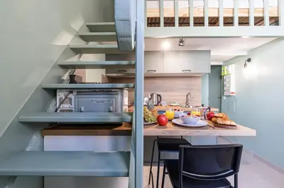 a kitchen with a counter with a table and chairs at MY CASA - SAINT SIAGRE 3 - Near Jean Medecin in Nice
