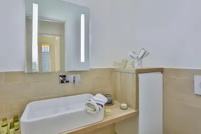 a bathroom with a white sink and a mirror at MY CASA - FRANCE 82 TP -1 min from the Sea - Terrace - Parking in Nice
