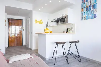 a living room with a counter and two stools at MY CASA - BUFFA 21 - 2min from the Sea - Terrace in Nice