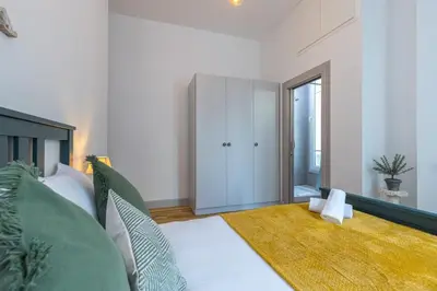 a bedroom with a bed and a cabinet in it at MY CASA - FRICERO - Comfortable 5 people- 200m near the Sea in Nice
