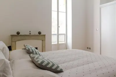 a white bedroom with a bed with two pillows at MY CASA - VEILLON - 2 bedrooms - City Center in Nice