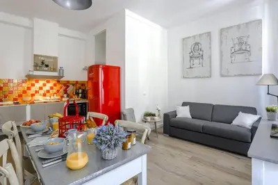 a kitchen and living room with a table and a red refrigerator at MY CASA - CASSINI GT - 1 bedroom - Balcony - Place Garibaldi in Nice