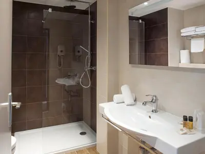 a bathroom with a sink and a shower at Hôtel Esprit d'Azur in Nice