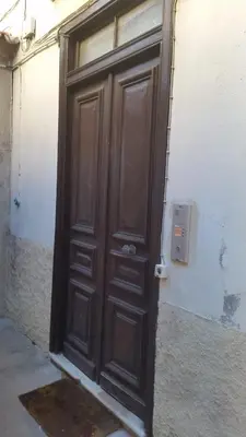 a large wooden door on the side of a building at Casa Madere- Idéal Couples - Central & cosy -Train station - Tram & Supermarkets-Balcony- Washing-machine-AC in Nice