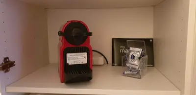 a red heater on a shelf next to a box at Affitto-Nizza in Nice