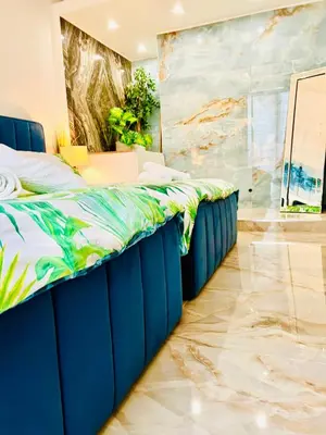 a bedroom with a blue bed and a painting on the wall at Endless Stunning Mediterranean Sea Views Promenade Des Anglais in Nice