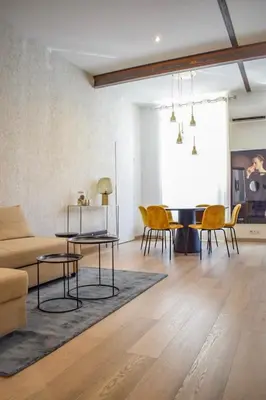 a living room with a couch and chairs and a table at Résidence Barla in Nice
