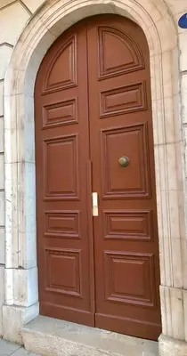 a large wooden door in a building at Résidence Barla in Nice