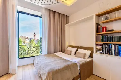 a bedroom with a bed and a large window at GRAND HÔTEL Golden Square 3 min to Beach Green Corridor View AC in Nice
