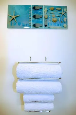 a group of towels on a towel rack with a painting at Studios Nice French Riviera in Nice