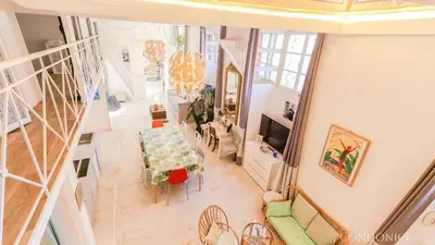 an overhead view of a living room with a table and chairs at CondoNice in Nice