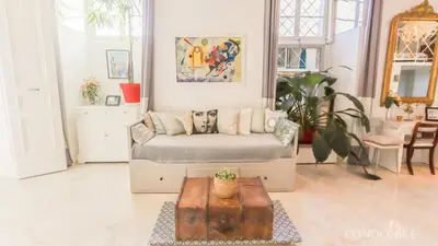 a living room with a couch and a table at CondoNice in Nice