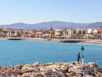 a person standing on the rocks near the water at Apartment L'Angelina-1 by Interhome in Cros-de-Cagnes