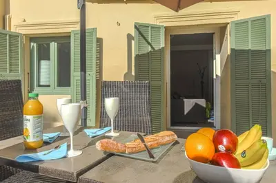 a table with a bowl of fruit and wine glasses at MY CASA - JOFFRE 9 - Near Masséna Square - Terrace in Nice