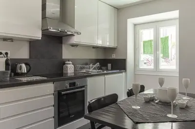 a kitchen with a table and a dining room at MY CASA - JOFFRE 9 - Near Masséna Square - Terrace in Nice