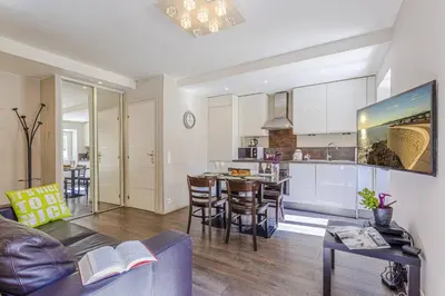 a living room and kitchen with a couch and a table at MY CASA - JOFFRE 9 - Near Masséna Square - Terrace in Nice