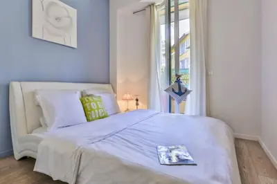 a bedroom with a white bed and a window at MY CASA - FRANCE 82 D - 2 rooms - Terrace - 1 min to the Sea in Nice