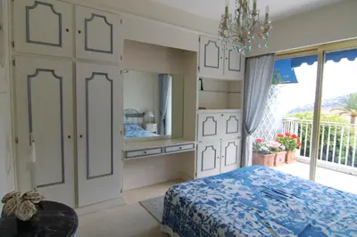 a bedroom with a bed and a large window at La Reale in Villefranche-sur-Mer