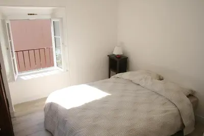 a white bedroom with a bed and a window at Apartment Lisa Acropolis Garibaldi in Nice