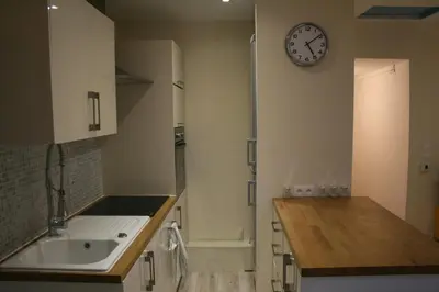 a kitchen with a sink and a clock on the wall at Apartment Lisa Acropolis Garibaldi in Nice