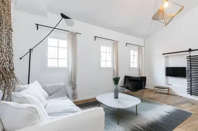 a white living room with a white couch and a table at Malonat Duplex - Old Town in Nice