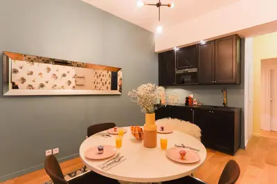 a dining room with a table and chairs in a kitchen at Moulin -Old Town in Nice
