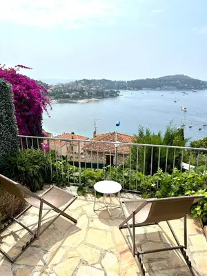 a patio with chairs and a view of the water at Studio Leopolda in Villefranche-sur-Mer