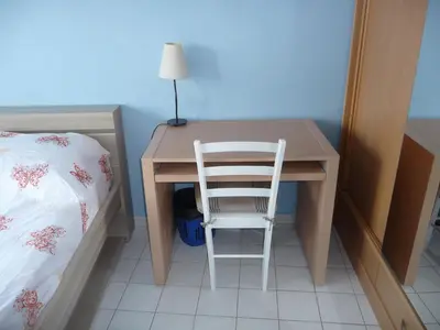 a desk with a chair next to a bed at Chambre chez l'habitant Nice Baie des Anges in Nice