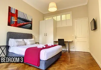 a bedroom with a bed and a desk in it at Nestor&Jeeves - PALAIS ARNULF - Central - Very close sea in Nice