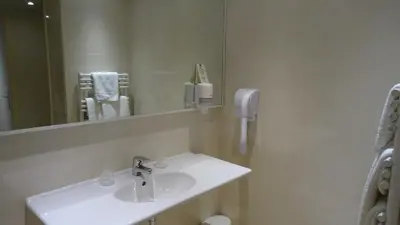 a hotel room with a desk and a bed at Residence Club Inn in Nice