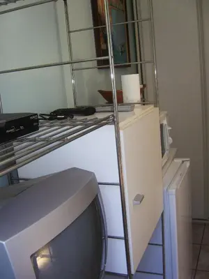 a room with a television and a shelf with a tv at Les lilas blancs in Villefranche-sur-Mer