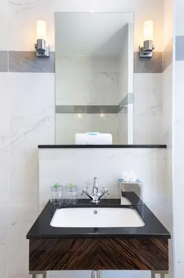 a bathroom with a sink and a mirror at The Jay Hotel by HappyCulture in Nice