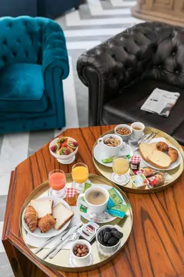 a coffee table with two plates of food on it at The Jay Hotel by HappyCulture in Nice