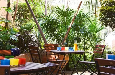 an outdoor table with chairs and a table with drinks on it at Residhome Nice Promenade in Nice