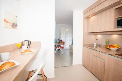 a kitchen with a counter and a table with bread at Residhome Nice Promenade in Nice