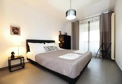 a bedroom with a large bed and a window at Nice Étoile Grand Suite Five stars Holiday House in Nice