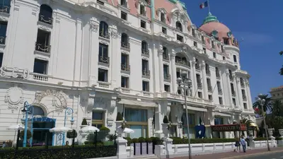a large white building on the side of a street at Palais Rialto in Nice