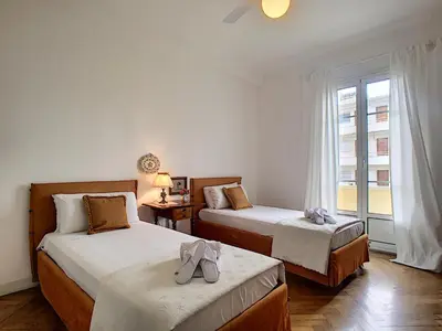 a bedroom with two beds and a window at Nestor&Jeeves - PALAIS NICOLE - Central - Very close sea in Nice