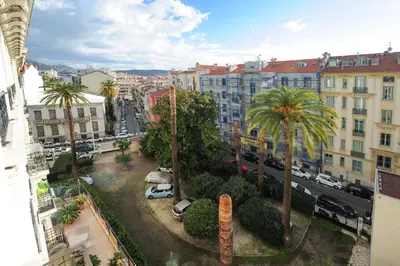 a view of a city with palm trees and buildings at Appartement Clemenceau Centre Nice Five stars Holiday House in Nice