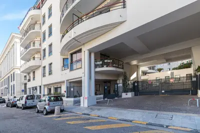 a building with cars parked in a parking lot at Nice 1 Bedroom downtown Carré d'Or with garage in Nice