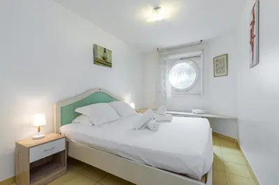 a bedroom with a white bed and a window at Nice 1 Bedroom downtown Carré d'Or with garage in Nice